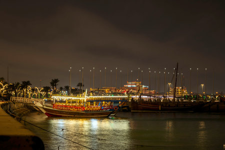 Traditional boats called Dhows are anchored in the port near Museum of Islamic Art Park.のeditorial素材