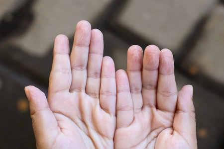 Wrinkled fingers from playing in the water for too long with a blurry backgroundの写真素材