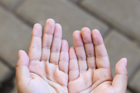 Wrinkled fingers from playing in the water for too long with a blurry backgroundの写真素材