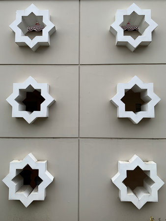 closeup of a wall Symmetrical White Star-Shaped Openings on Walls of Modern Geometric Architectural Detailsの写真素材