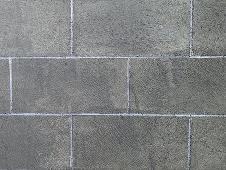 Background of stone wall texture. Close-up of grey brick wall.の写真素材