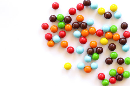 Colorful candies on white background. Top view with copy spaceの写真素材