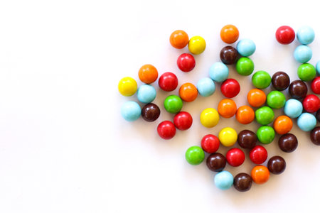 Colorful candies on white background. Top view. Copy space.の写真素材