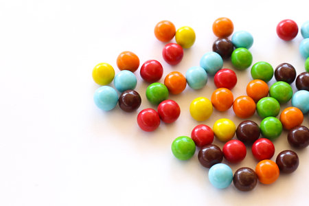 Colorful candies isolated on a white background. Top view.