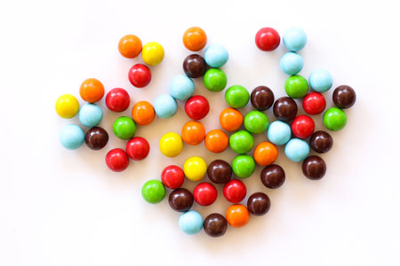 Colorful candies in heart shape on white background, stock photoの写真素材