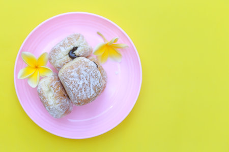 Pink Plate with Bright Yellow Background Donutの写真素材
