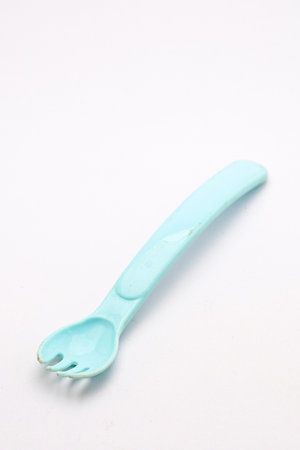Colored plastic spoon with a soft curved handle, suitable for children, picnics, and everyday meals.の写真素材