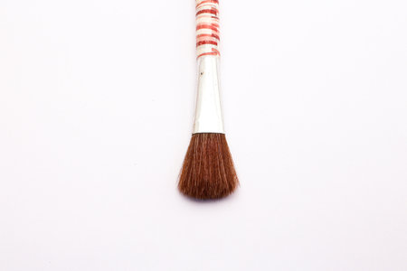 Wooden Handled Makeup Brush Isolated Against a white Background. ideal for cosmetics-related projects.の写真素材