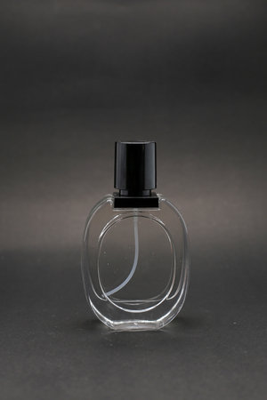 Elegant Three Glass Perfume Bottles Against a Minimalist Dark Background.の写真素材