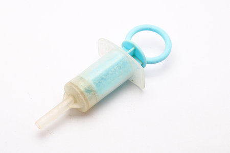 Used Medicine Feeder on white Backgroundの写真素材