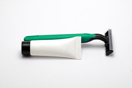 Close-Up of Isolated Razor and Cream for Personal Grooming and Hygieneの写真素材