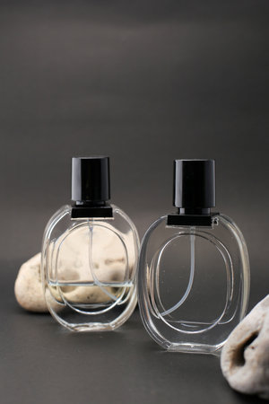 Elegant Three Glass Perfume Bottles Against a Minimalist Dark Background.の写真素材