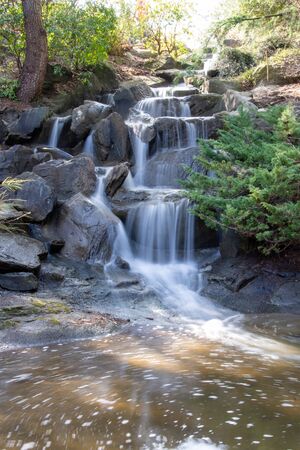 Long exposure shot of a small waterfall and a swirling pool of water.  Vancouver BC Canada