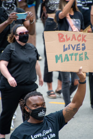 Juntenth Protestors holding up signs during anti-racism march.   Vancouver BC Canada June 19th 2020