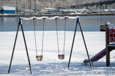 Some Playground Swings Covered in Snow   Vancouver BC Canadaãの写真素材