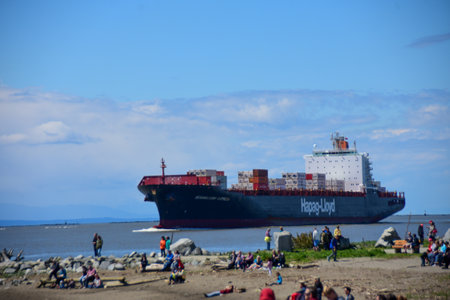 A container ship  carrying  many containers.      May 6th 2017   Richmond BC Canada