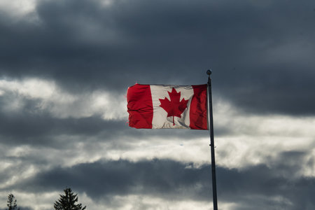 A view of the Canadian flag waving against the cloudy sky.  Burnaby BC Canadaの写真素材