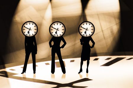 three modern businesswomen with a business clockの写真素材