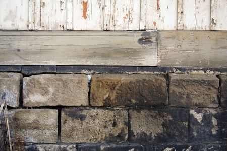 stones and foundation of an old wooden houseの写真素材
