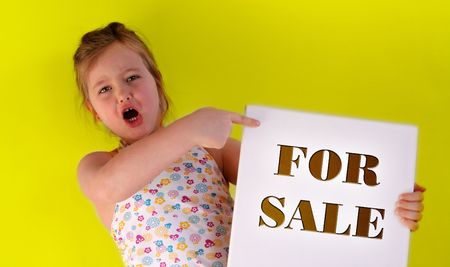 A girl is holding a frame in her handsの写真素材