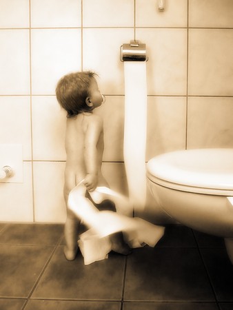 Little boy is playing with the toilet paperの写真素材