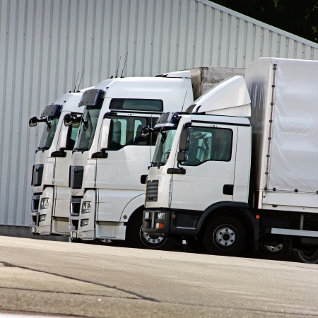 three white trucks are waiting in a rowのeditorial素材