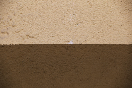 Painted two-tone wall with small concrete structureの写真素材