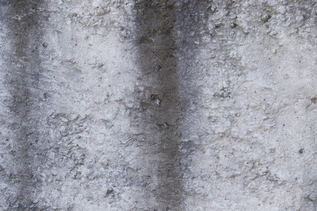 Old concrete wall with cracks and potholesの写真素材