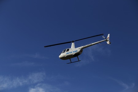 Minsk, Belarus on 18-19 July 2015. Air sports festival "Clean Sky" Passenger helicopters Mi-2 and Robinson, at work, flying in the air, taking off and landing, transportation of passengers.のeditorial素材