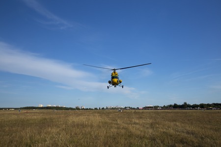 Minsk, Belarus on 18-19 July 2015. Air sports festival "Clean Sky" Passenger helicopters Mi-2 and Robinson, at work, flying in the air, taking off and landing, transportation of passengers.のeditorial素材