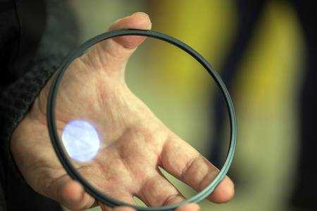 Protective Filter for large camcorder in a mans hand. polarizing .の写真素材