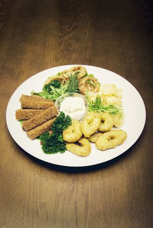  Appetizer made of fried onion, potato and breadの写真素材