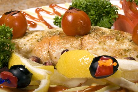 Fried filleted fish with lemon and vegetablesの写真素材