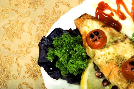 Fried filleted fish with lemon and vegetablesの写真素材