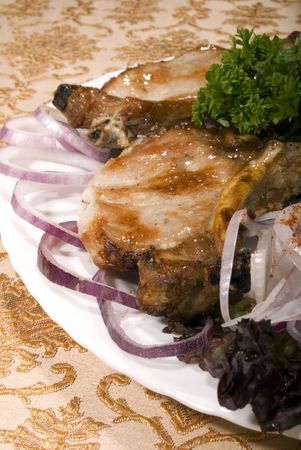 Fried juicy meat served with vegetablesの写真素材