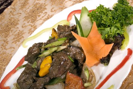 Fried juicy meat served with vegetables の写真素材