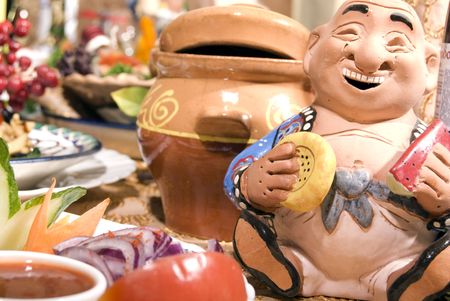  A table with some dishes and ceramic figurine の写真素材