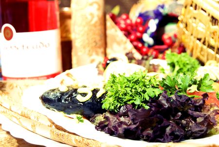 Served table with a dish with fish in foregroundの写真素材