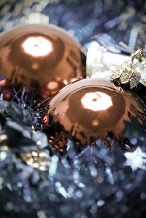Red Christmas balls with blue tinsel and silver bell close-upの写真素材