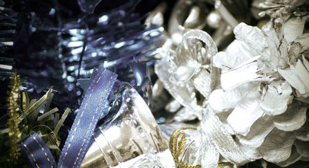 Christmas silver bells, blue tinsel,  and decorative cone