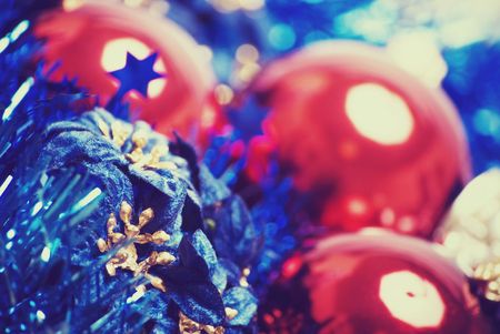 Red Christmas ball with blue tinsel and flowers close-upの写真素材