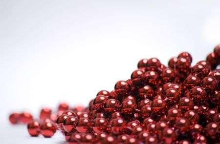 Red Christmas beads isolated on white backgroundの写真素材