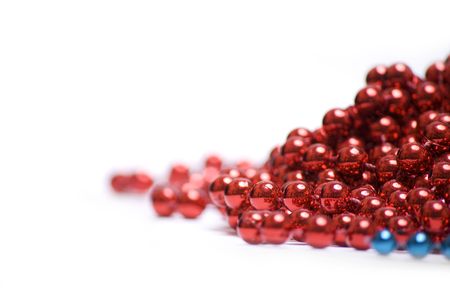 Red Christmas beads isolated on white backgroundの写真素材