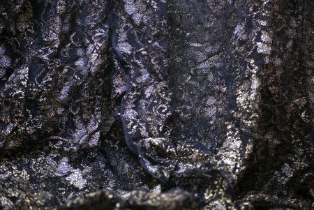 Black glittering textile shot with gold  