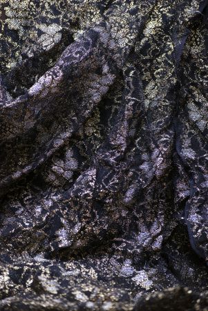 Black glittering textile shot with gold 