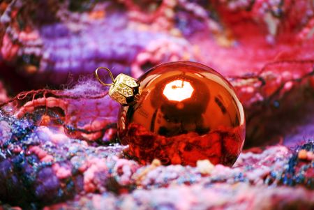 Red Christmas ball on the soft colorful materialの写真素材