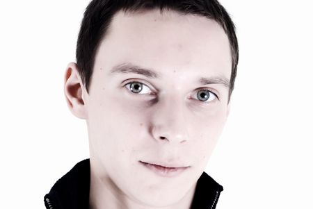 Portrait of a young dark-haired man over white close-upの写真素材