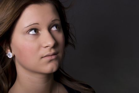 Portrait of a young  beautiful brunette with her hair blowing out の写真素材