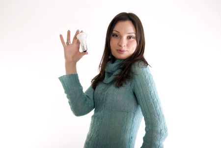 Portrait of a young beautiful brunette holding a electric light bulbの写真素材