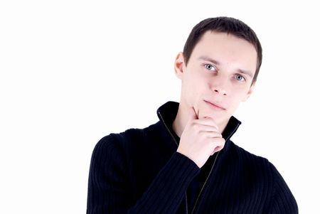 Portrait of a young dark-haired man with his hand on the chinの写真素材